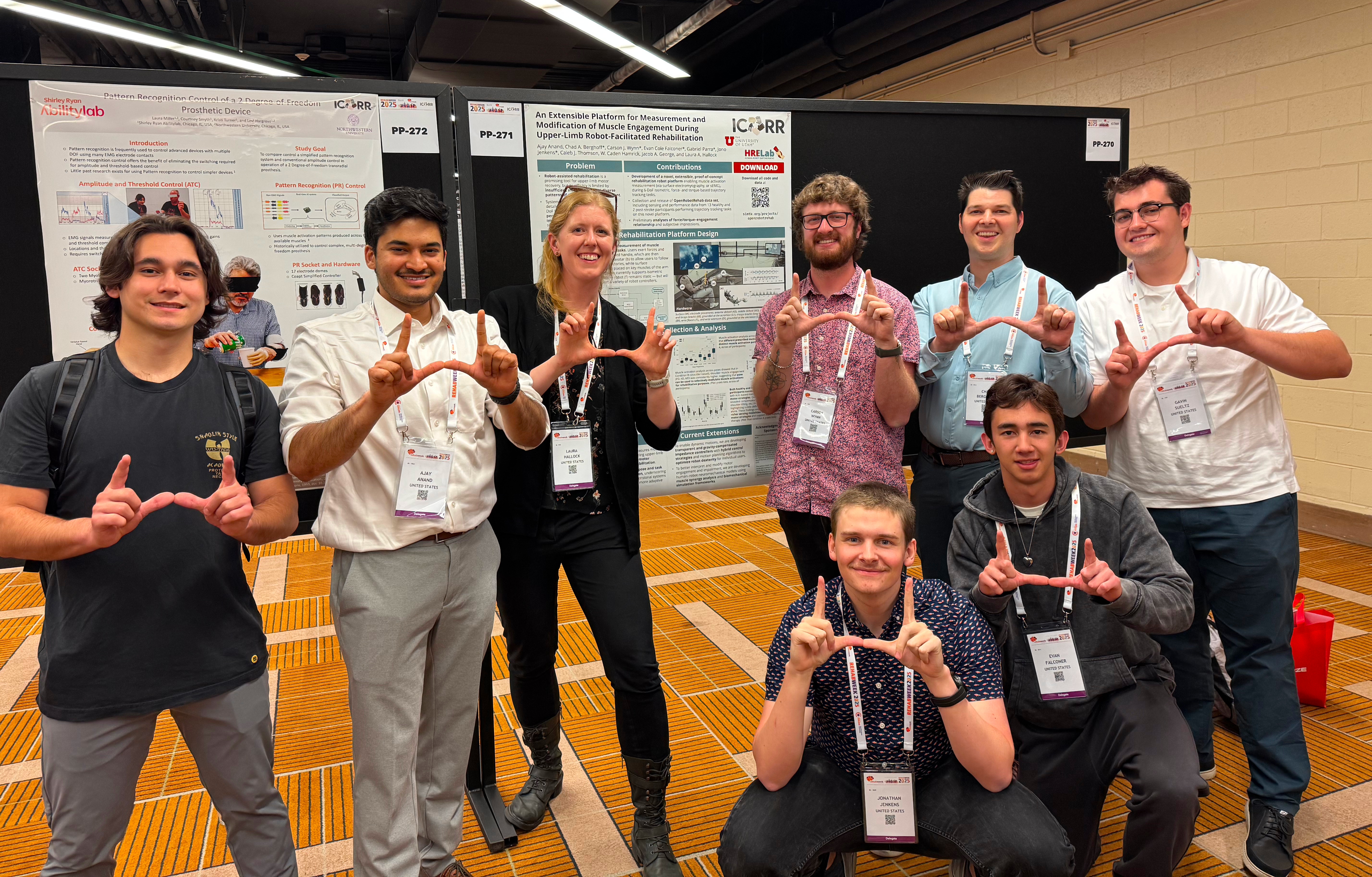 HRELab members pose together at the ICORR conference poster session.